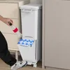 A person is shown placing a plastic bottle into a white multi-compartment trash can. Voir les images du produit