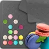 A collection of silicone macaron mats and colorful macarons. Podgląd zdjęcia produktu