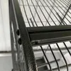 A close-up view of the metal frame and wire mesh of a large bird cage. Náhled obrázku produktu