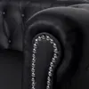 Close-up of a black leather armchair armrest. Produktbild-Vorschau