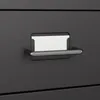 Close-up of a black filing cabinet drawer with a silver handle and a blank white label holder. Podgląd zdjęcia produktu