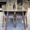 A dining table with chairs in a modern kitchen setting. Produktbild-Vorschau