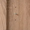 A close-up view of a wooden surface with two small metal fixtures and two drilled holes. Produktbild-Vorschau