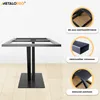 A black metal table base is shown on a wooden floor, with close-up images and text highlighting its features. Voir les images du produit