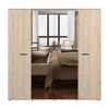 A wardrobe with mirrored doors reflecting a bedroom interior. Produktbild-Vorschau