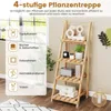 A wooden plant stand with various items displayed on its shelves, set in a room with natural light coming from a window. Anteprima dell’immagine prodotto