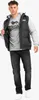 A man wearing a black puffer vest over a gray hoodie and jeans, posing against a white background. Anteprima dell’immagine prodotto