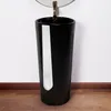 A black pedestal sink with a gold faucet and a circular mirror above it, set against a white wall and a wooden floor. Produktbild-Vorschau
