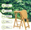 A foldable bamboo bar stool is shown in front of a backdrop of lush green bamboo leaves. Several feature callouts are present on the left side of the image. Produktbild-Vorschau