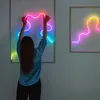 A person is interacting with a neon light installation on a wall. Produktbild-Vorschau