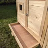 A close-up view of a wooden animal hutch with a pull-out tray. Produktbild-Vorschau