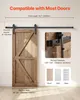 A wooden barn door is shown installed with a black sliding track system against a light gray wall. Produktbild-Vorschau