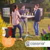 People gathered around a high table in an outdoor setting, possibly a garden party or event. Anteprima dell’immagine prodotto