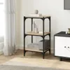 A three-tiered shelf unit with a wood and metal construction, placed in a room setting next to a window with sheer curtains and a cabinet. Náhled obrázku produktu
