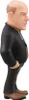A side view of a figurine of a bald man in a suit. Podgląd zdjęcia produktu
