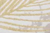 A close-up view of a textured rug with a gold leaf pattern. Produktbild-Vorschau