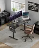 A modern home office setup with a standing desk, computer monitors, and a chair. Produktbild-Vorschau