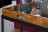 A close-up view of a wooden tray with a black metal frame, resting on a table. The tray contains two glass jars filled with water and a grey decorative object. Produktbild-Vorschau