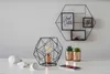 A modern desk setup with a geometric lamp, LED bulbs, small potted plants, and a smartphone. Produktbild-Vorschau