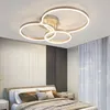 A modern bedroom with a stylish ceiling light fixture above a bed. Podgląd zdjęcia produktu