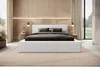 A modern bedroom with a white upholstered bed. Produktbild-Vorschau