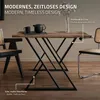 A dining table with a rustic wooden top and black metal X-shaped legs, set in a room with chairs and a vase of flowers. Náhled obrázku produktu