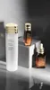 Three Estee Lauder skincare products are arranged on a reflective surface with a marble-like background. Podgląd zdjęcia produktu
