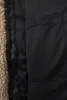 A close-up view of the inside lining of a jacket, showing a zipper and textured fabric. Produktbild-Vorschau