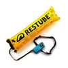 A yellow inflatable safety buoy with a black strap and a small blue pouch. Podgląd zdjęcia produktu