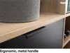 A close-up view of a drawer handle on a piece of furniture, with a textured basket on top. Produktbild-Vorschau