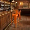 A bar interior with wooden paneling, shelves stocked with bottles, and two orange bar stools. Podgląd zdjęcia produktu