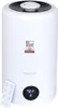 A white humidifier with a black top and a remote control in front of it. A digital display shows '21' and '3'. There is a seal of 'TEST DEUTSCHLANDS BESTE' on the front. Produktbild-Vorschau