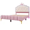 A pink upholstered bed frame with a crown-shaped headboard. Podgląd zdjęcia produktu