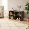 A living room scene with wooden crates used as shelving, displaying books, plants, and decorative items. Náhled obrázku produktu