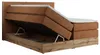 A king-size boxspring bed with its storage compartment open, revealing the lifting mechanism and storage space. Produktbild-Vorschau