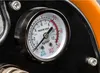 A close-up of a pressure gauge on a machine. Produktbild-Vorschau