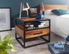 A nightstand next to a bed in a bedroom setting. Podgląd zdjęcia produktu