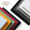 A stack of colorful fabric swatches, likely representing different colors of a textile product, with a certification label in the upper left corner. Anteprima dell’immagine prodotto
