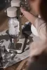 A person is using a water carbonator to make sparkling water. Produktbild-Vorschau