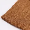 A close-up view of a piece of brown coconut fiber matting. Voir les images du produit
