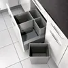 A kitchen drawer is open, revealing a built-in waste sorting system with multiple bins. Another bin is placed outside the drawer. Produktbild-Vorschau