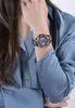 A woman's arm wearing a Guess watch. Náhľad obrázku produktu