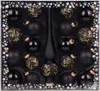 A set of black Christmas ornaments and a tree topper in a box. Produktbild-Vorschau