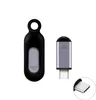 Two electronic accessories are displayed on a white background. One is a black, oval-shaped device with a loop at the top and a gray oval insert. The other is a silver, rectangular device with a black top and a USB-C connector at the bottom. A close-up of  Produktbild-Vorschau