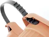 A close-up of a peach-colored plastic object with a gray strap and black plastic components. Náhľad obrázku produktu