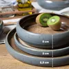 A stack of ceramic bowls with measurements indicated by white lines and text. Produktbild-Vorschau