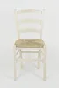 A front view of a white wooden chair with a straw seat. Produktbild-Vorschau