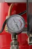 A close-up of a pressure gauge on a red air compressor. Náhľad obrázku produktu