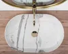 A top-down view of a marble sink with a gold faucet. Náhľad obrázku produktu