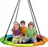 Three children are sitting on a round, multicolor nest swing. Produktbild-Vorschau